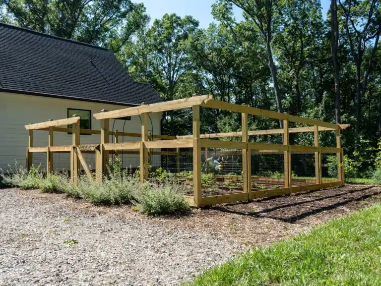Wood garden enclosure with pergola-style top and black wire mesh beside a Virginia home