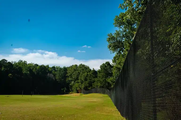 Tall black chain link fence running along a fairway at Brandermill Country Club
