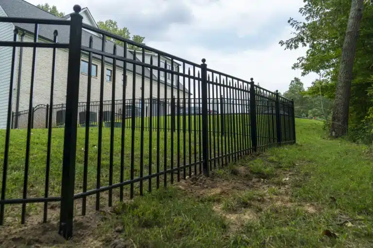 Siskin aluminum fence in Chester, VA racked along a sloped yard beside a new-build home