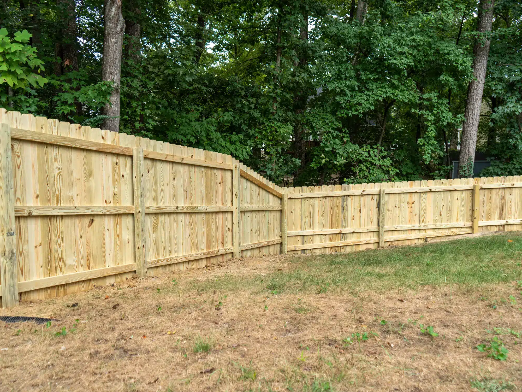 Dog-ear wood privacy fence in Short Pump stepping down from 6 feet to 4 feet, since height changes wood fence cost