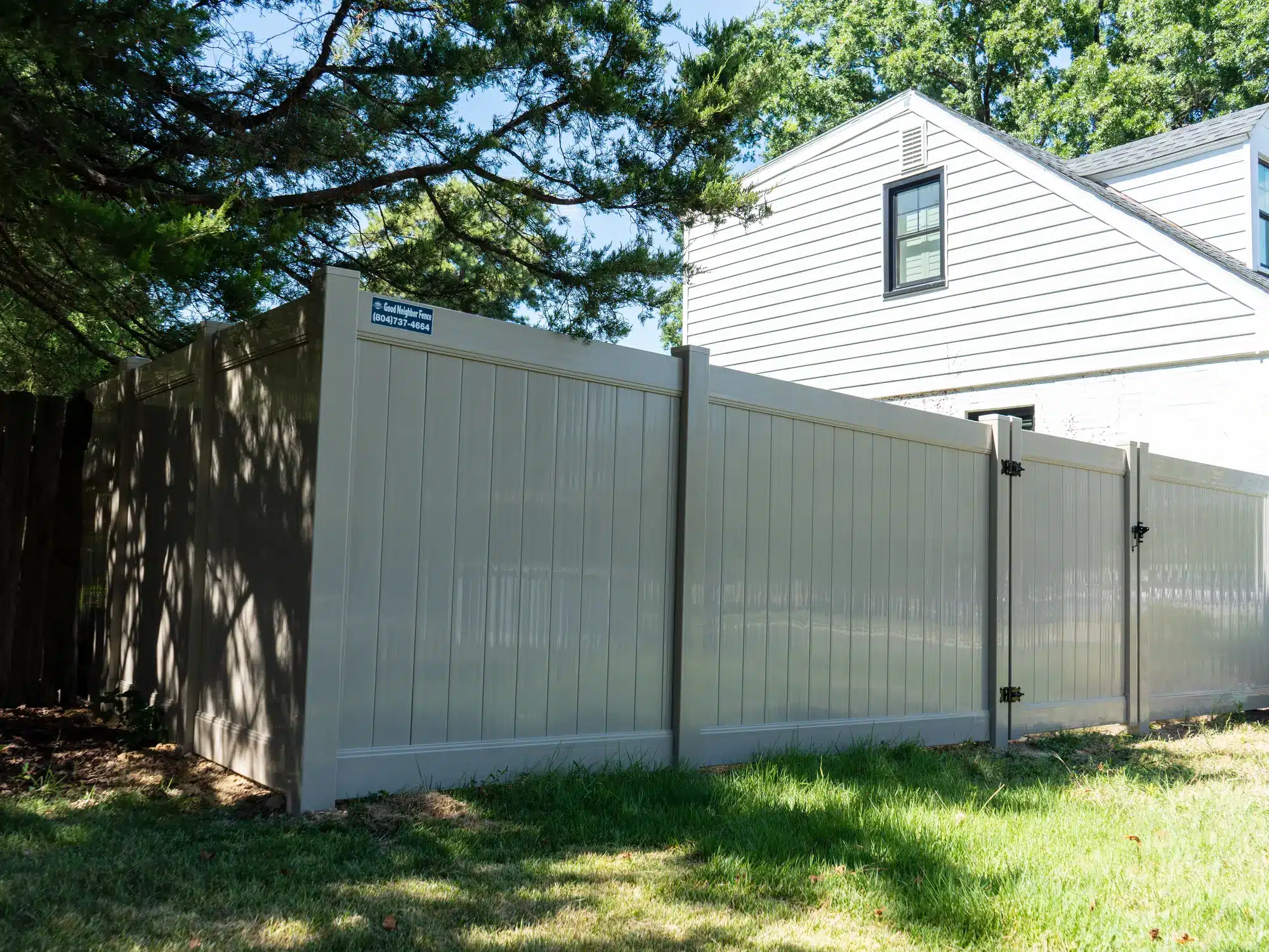 6 foot tan vinyl privacy fence with a walk gate beside a Henrico home