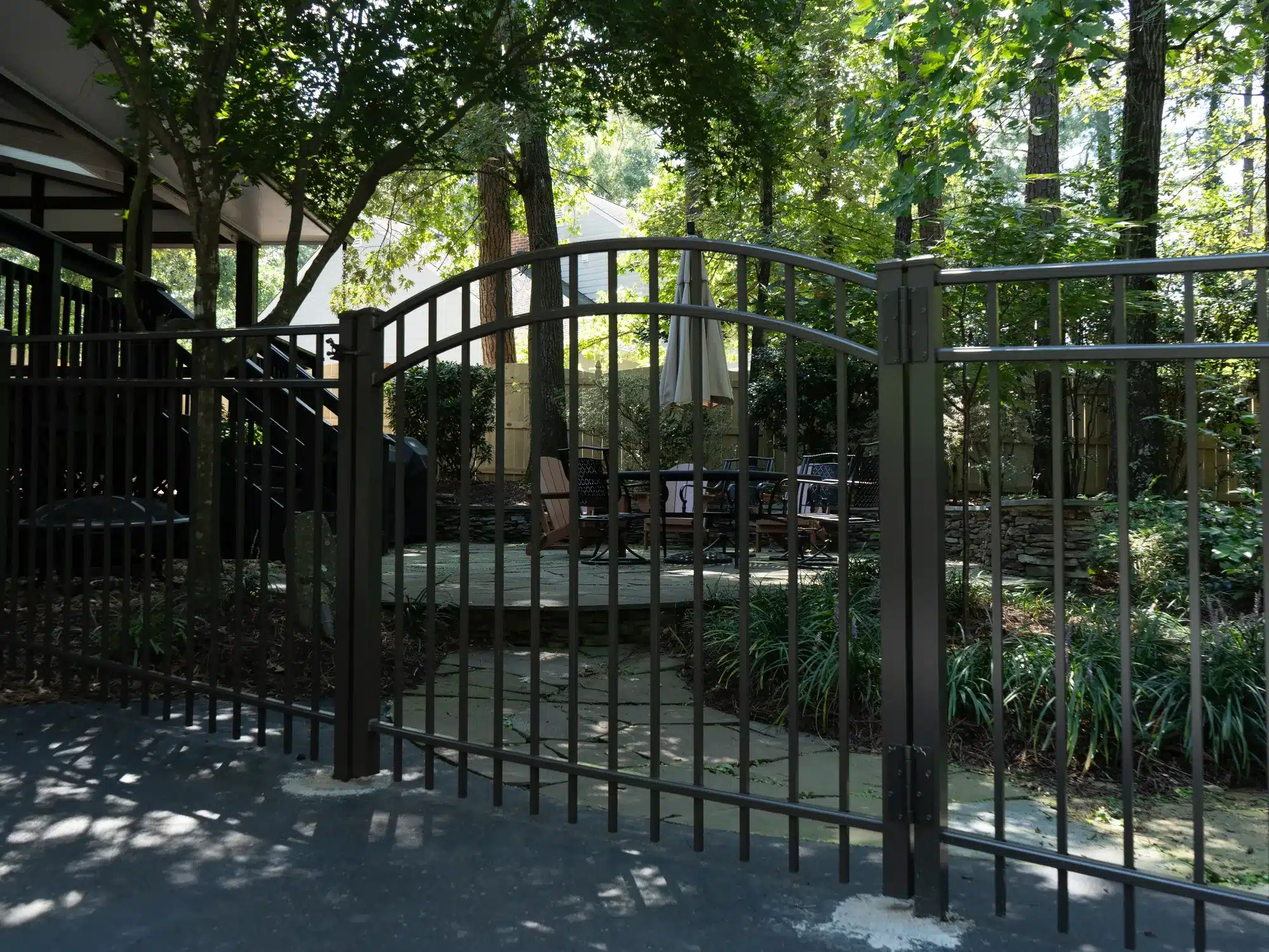 Bronze aluminum arched double gate across a driveway in Henrico, Virginia